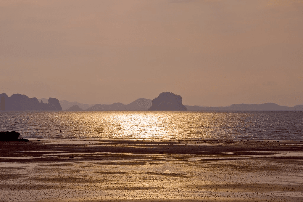 Soft sunset light over Klong Muang Beach with offshore islands on the Andaman Sea, Krabi