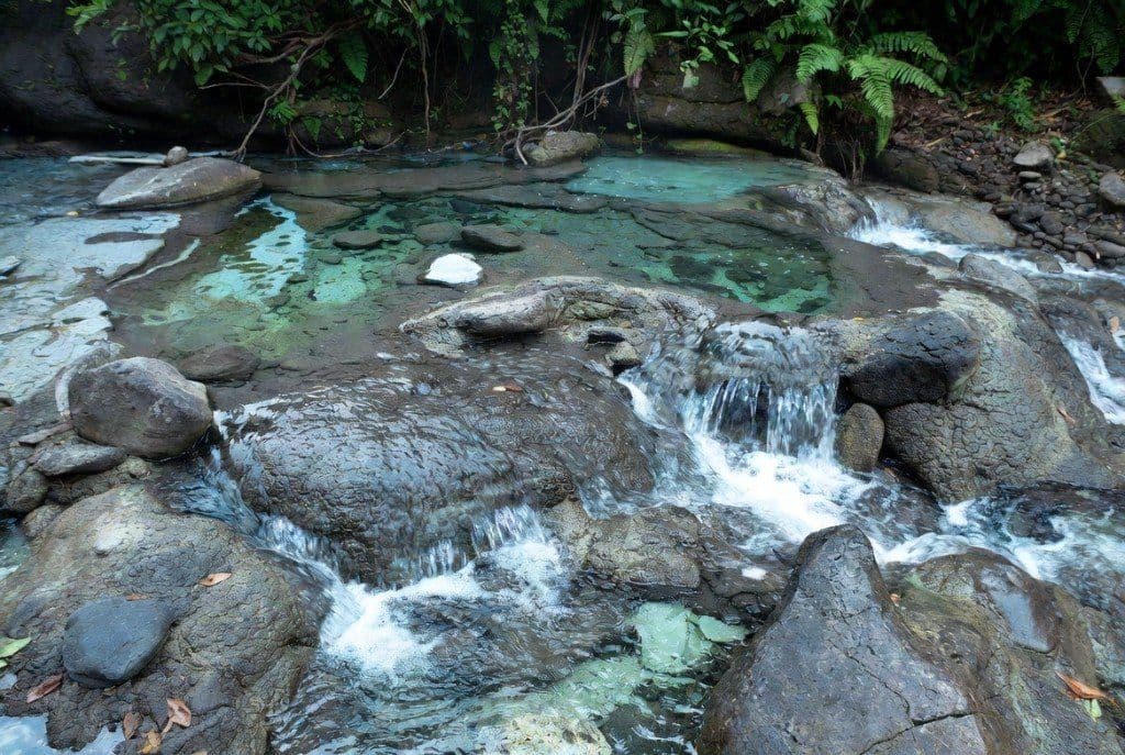 Krabi Hot Springs thermal waterfall and rock pools in the rainforest at early morning, Khlong Thom